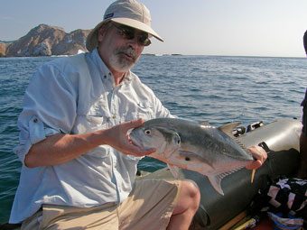 Andrew holding the Jack fish he caught.