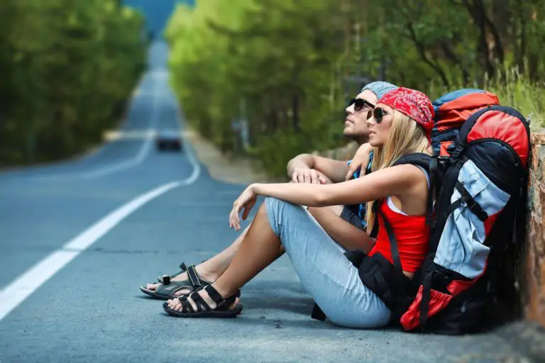 Backpackers resting on the road