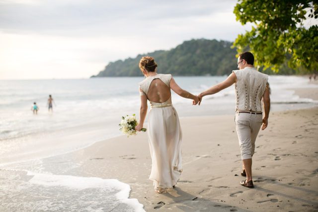 Newlyweds love to walk on the beach and feel the fresh sea breeze around them.