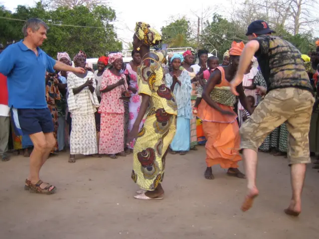Tourists dancing an ethnic dance in Africa.