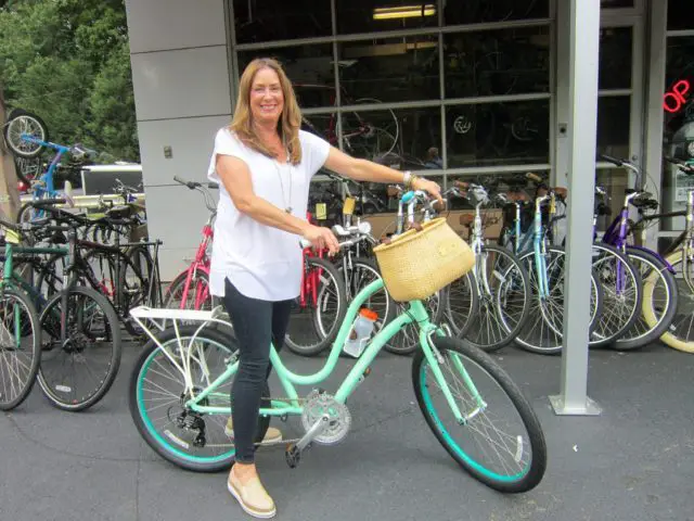 A happy woman with her bike