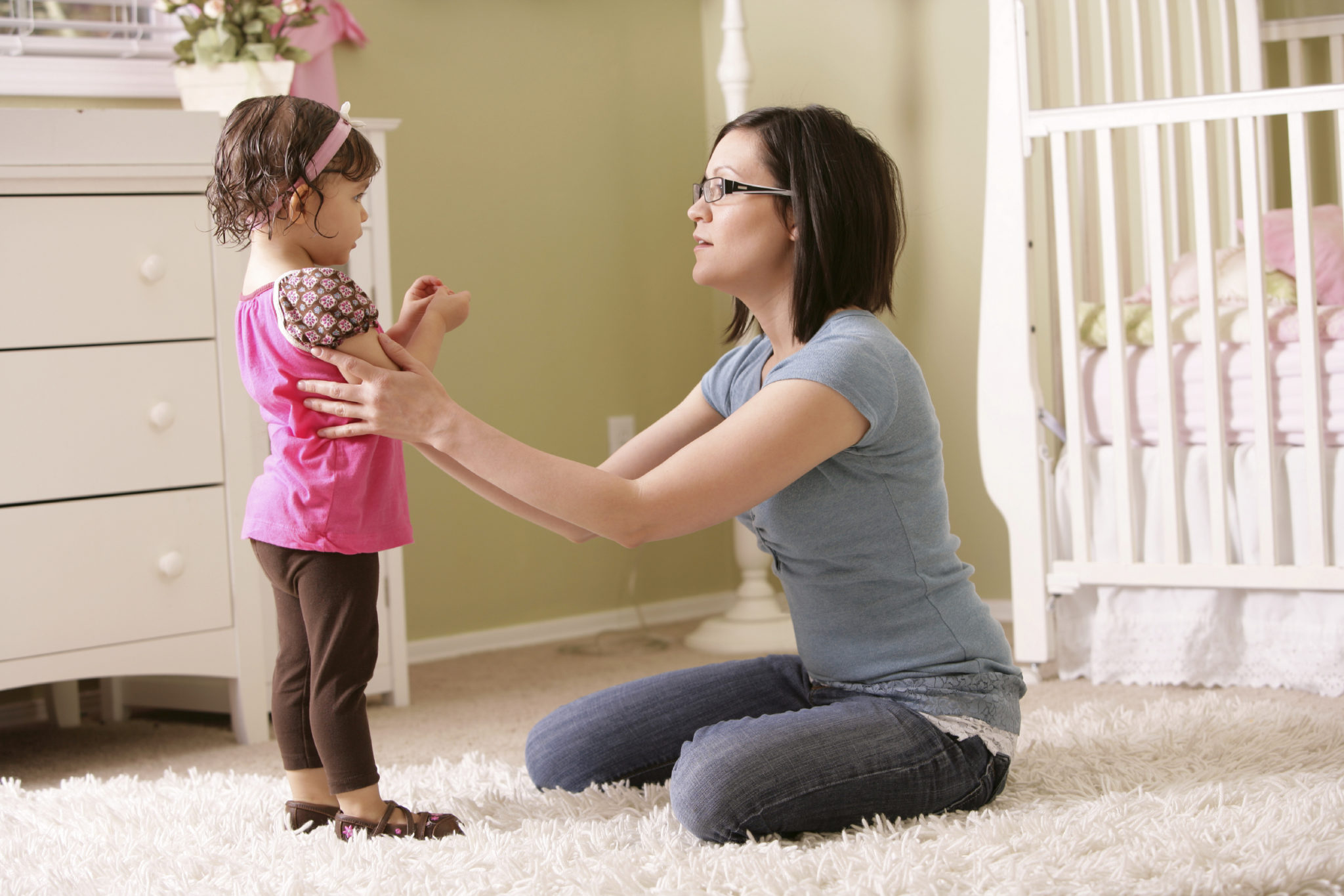 A mom listening to her little girl with love.