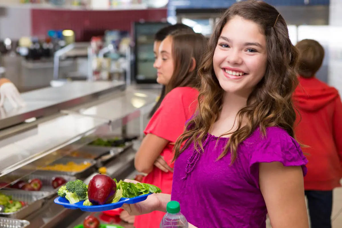 She have lunch at school. Have lunch at School photo for teenagers.