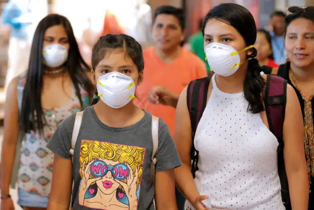 Passengers wear protective face masks as a precaution against the spread of the new Coronavirus, COVID-19, at Jorge Chavez International Airport, in Lima, on March 6, 2020. - Peruvian Government confirmed its first case of Coronavirus. President Martin Vizcarra reported that it is a 25-year-old male patient, who arrived from a trip to Spain, France and the Czech Republic. (Photo by Luka GONZALES / AFP) (Photo by LUKA GONZALES/AFP via Getty Images)